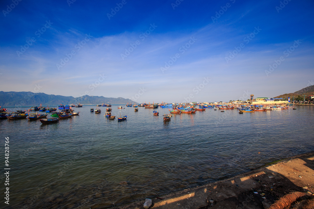 distant group of Vietnamese fishing boats against hilly islands