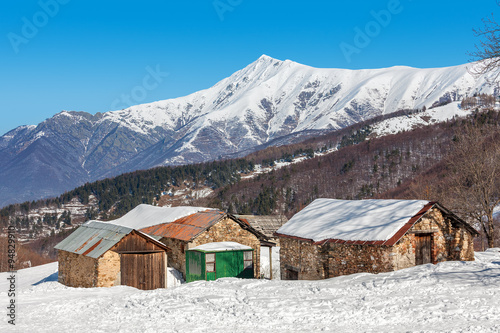 Rural houses and snowy mountains in Piedmont, Italy. © Rostislav Glinsky
