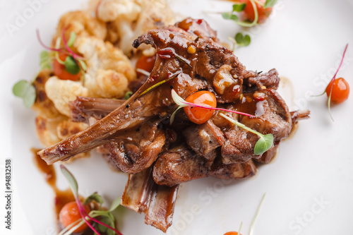 Grilled rack of lamb with vegetables.