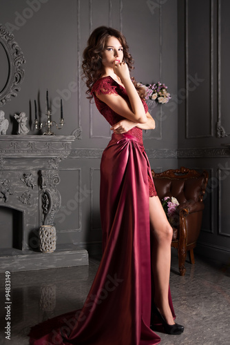 Attractive woman in long claret lace dress