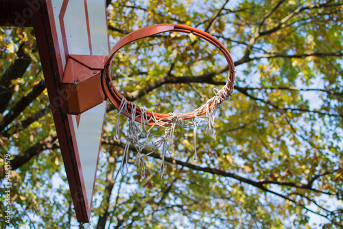 Fototapeta Naklejka Na Ścianę i Meble -  Basketball board and hoop in the park. Orange-white color.
