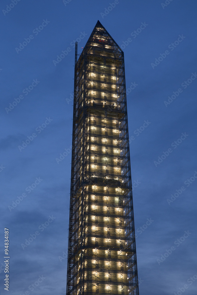 Washington Memorial at dusk with lights on, is covered in scaffolding as result of Earthquake, Washington, D.C., a US Icon. Washington Memorial at dusk with lights on, is covered in scaffolding as result of Earthquake, Washington, D.C., a US Icon.