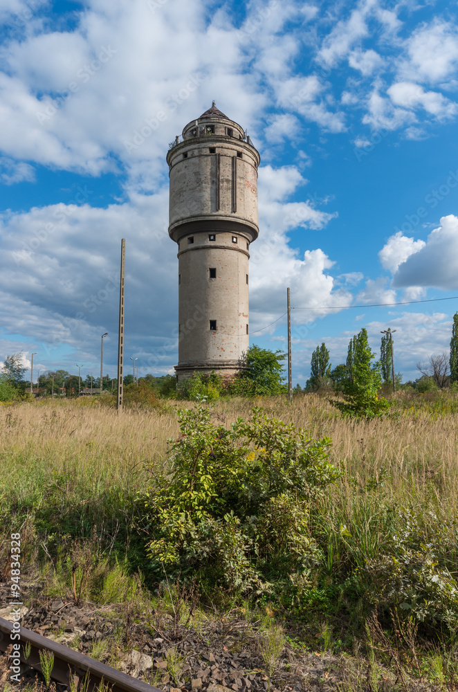 Abandoned water tower near old railway track