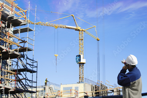 construction foreman directing site workers inside industry