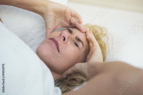 woman in bed in pain