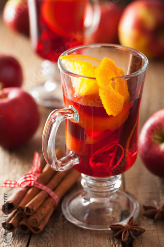 glass of mulled wine with orange and spices, winter drink