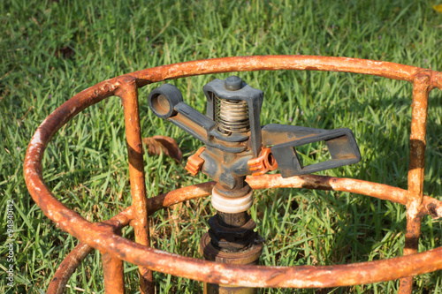 Old sprinkler head on the green grass