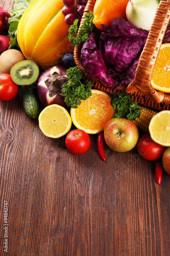 Fototapeta Naklejka Na Ścianę i Meble -  A set of fruit and vegetables in a basket on wooden background