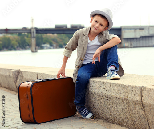 Little boy with suitcase on...
