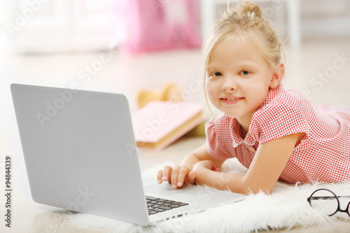 Little girl with laptop in ...