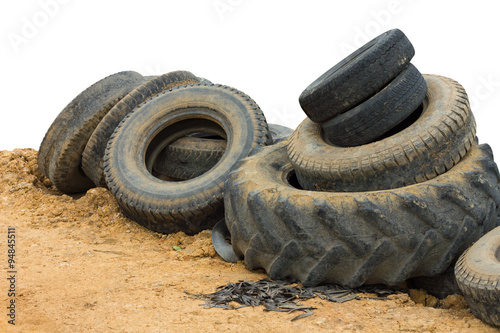 Tires in a pile on the ground.