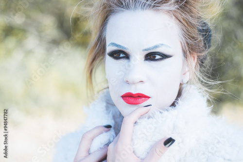 Ice princess  young woman with professional makeup posing outdoor