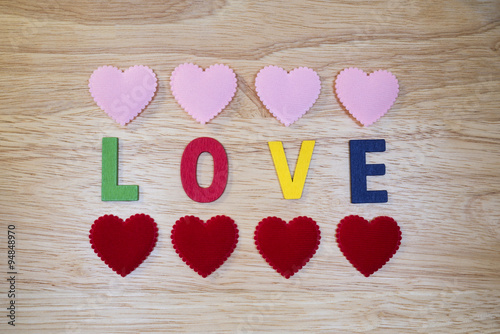 Word Love 4 - Colorful words "Love" made from wooden letters on wood background (Valentines day)