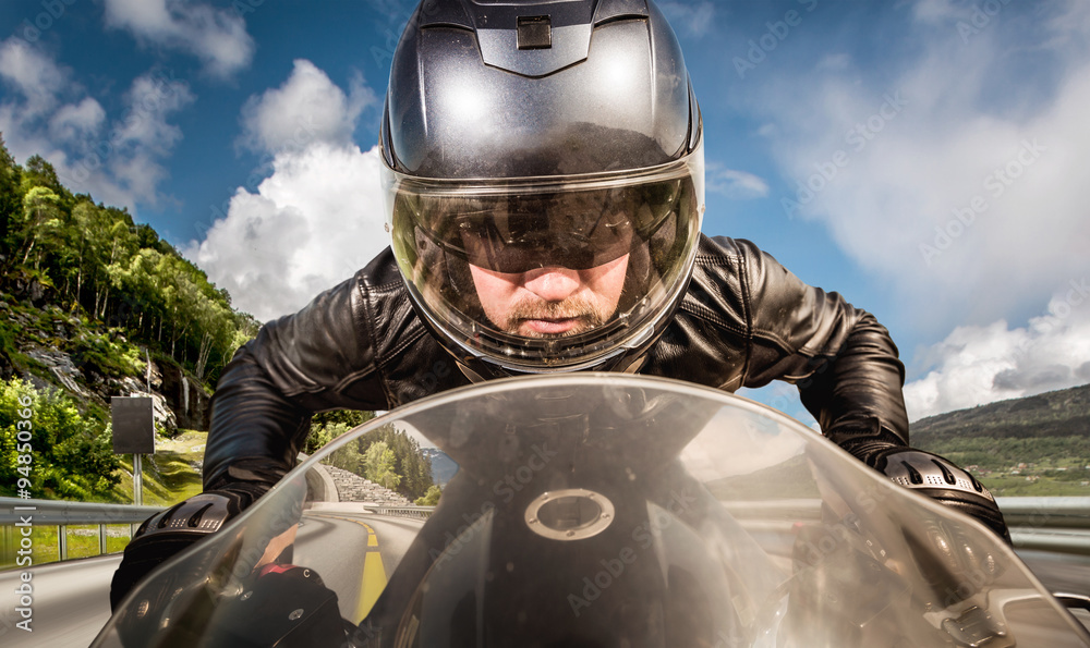 Naklejka premium Biker racing on the road