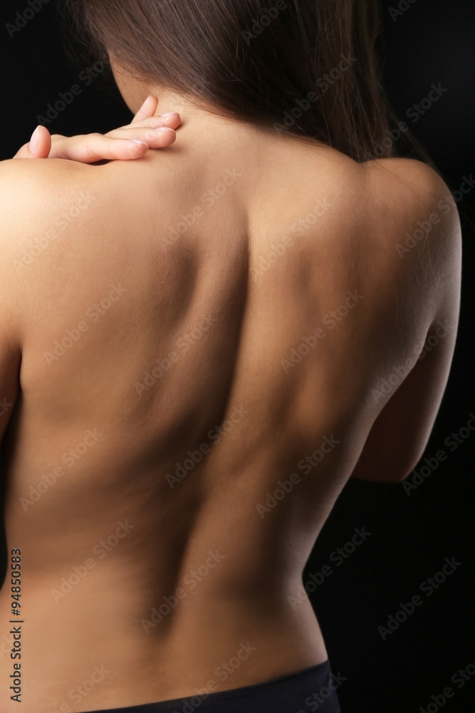 View on woman's nude back, close-up View on woman's nude back, close-up