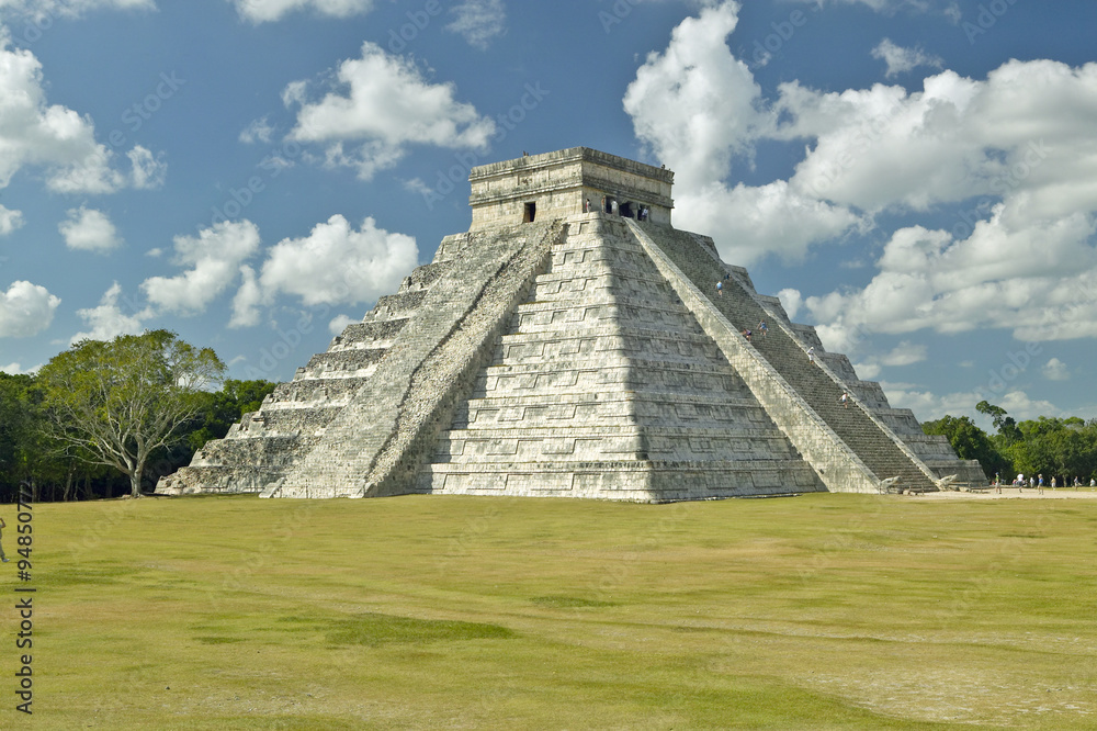 White puffy clouds over the Mayan Pyramid of Kukulkan (also known as El Castillo) and ruins at Chichen Itza, Yucatan Peninsula, Mexico