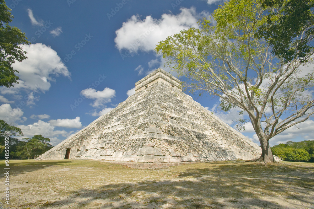 White puffy clouds over the Mayan Pyramid of Kukulkan (also known as El Castillo) and ruins at Chichen Itza, Yucatan Peninsula, Mexico White puffy clouds over the Mayan Pyramid of Kukulkan (also known as El Castillo) and ruins at Chichen Itza, Yucatan Peninsula, Mexico