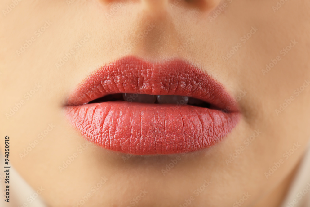 View on woman's beige lips, close-up View on woman's beige lips, close-up