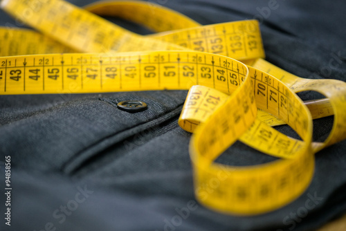 Measuring tape on pants in a tailor workshop