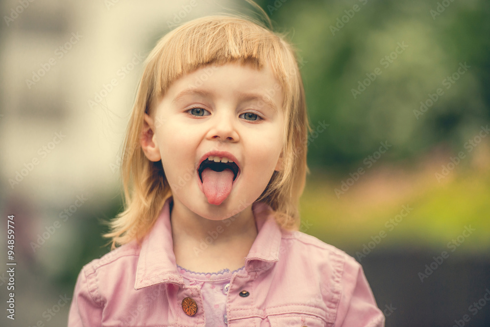 Beautiful girl showing tongue close up