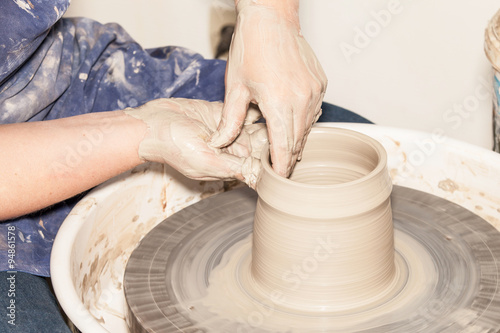 Female Potter creating a earthen jar on a Potter's wheel