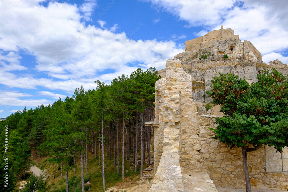 Ancient walls of Morella castle and the pine wood behind, the province of Castellon, Spain.