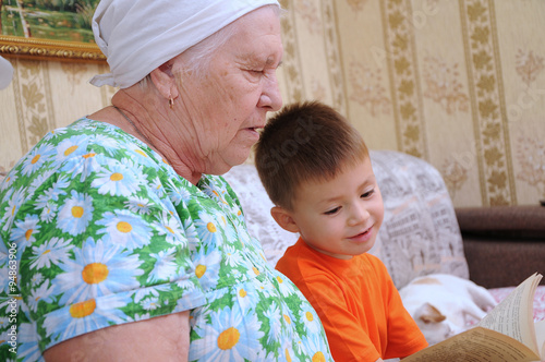 Grandmother and grandson reading book