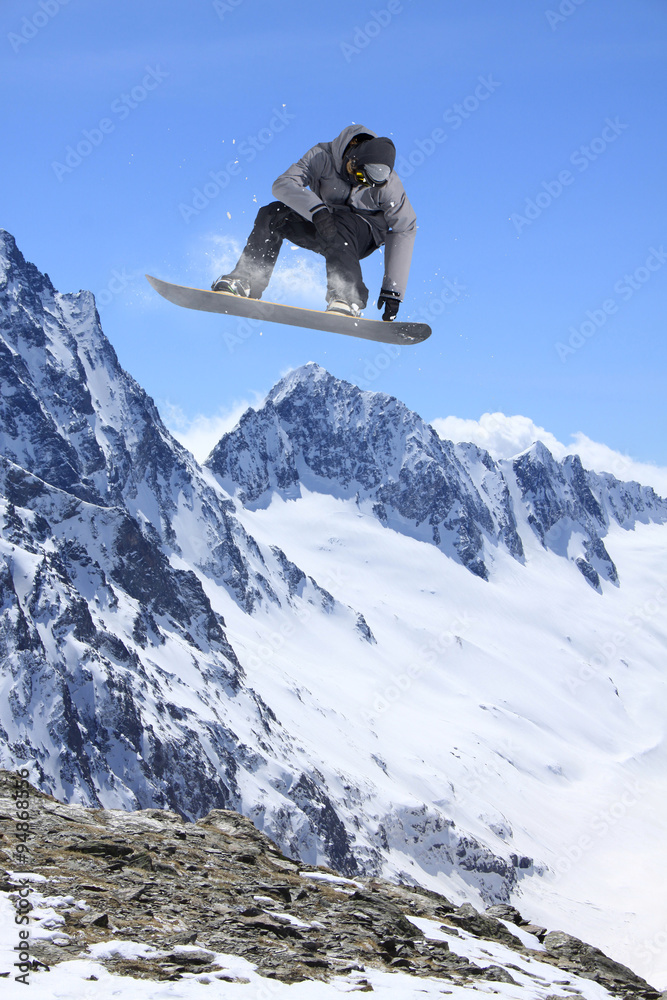 Flying snowboarder on mountains Flying snowboarder on mountains