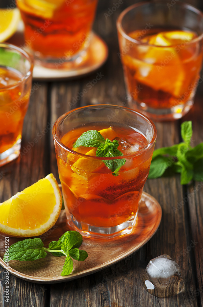 Glass of aperol with ice, orange and mint Glass of aperol with ice, orange and mint