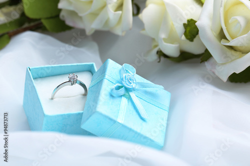 Diamond ring in box on a white cloth