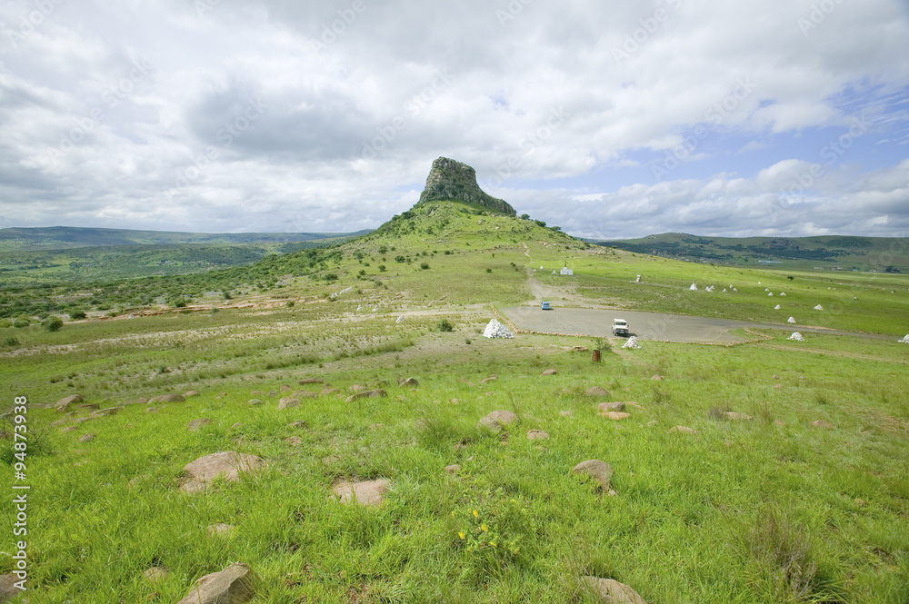 Sandlwana hill or Sphinx with soldiers graves in foreground, the scene of the Anglo Zulu battle site of January 22, 1879. The great Battlefield of Isandlwana and the Oskarber, Zululand, northern Kwazulu Natal, South Africa Sandlwana hill or Sphinx with soldiers graves in foreground, the scene of the Anglo Zulu battle site of January 22, 1879. The great Battlefield of Isandlwana and the Oskarber, Zululand, northern Kwazulu Natal, South Africa