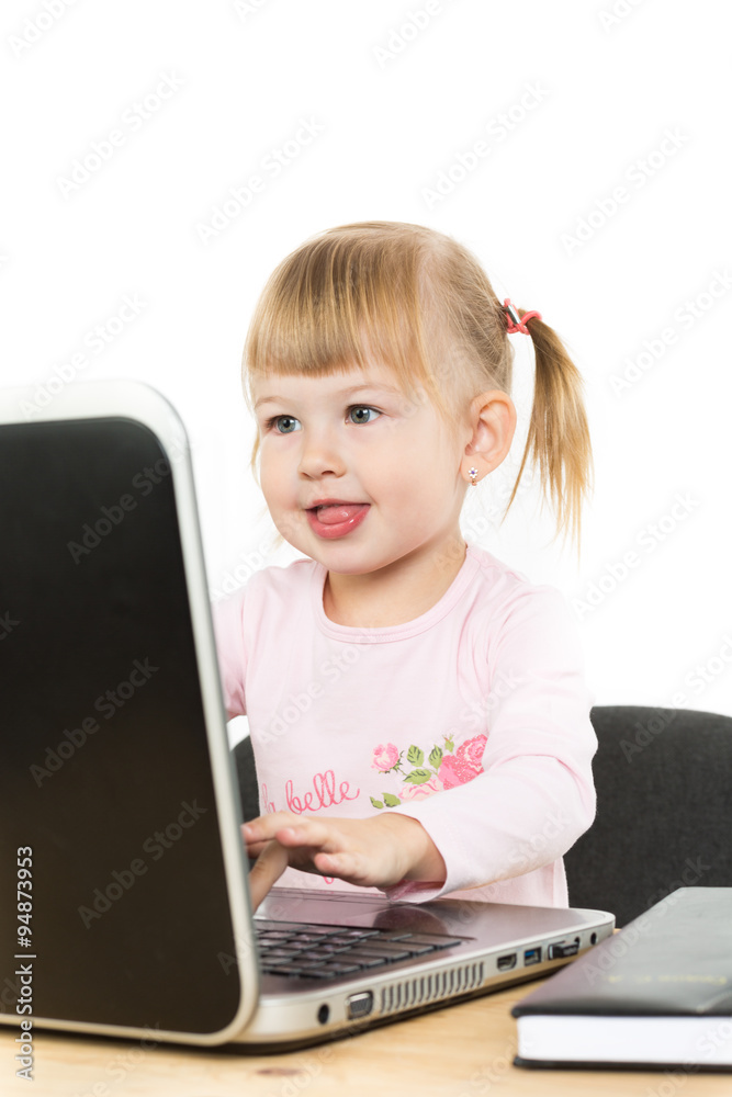 Cute little girl is sitting with laptop Cute little girl is sitting with laptop