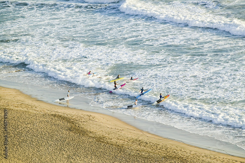 White surf and beach where surfer school sets out for surfing in Durban, South Africa on the Indian Ocean