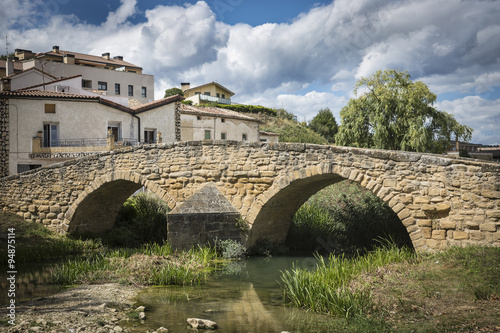 medieval bridge over iranzu river in Villatuerta town, Navarra, Spain photo