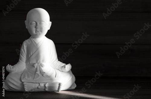 White monk statue. Sitting buddha. Meditation and relaxing