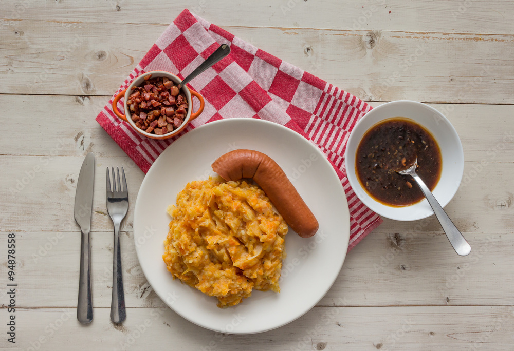 Hutspot with smoked sausage on a white plate