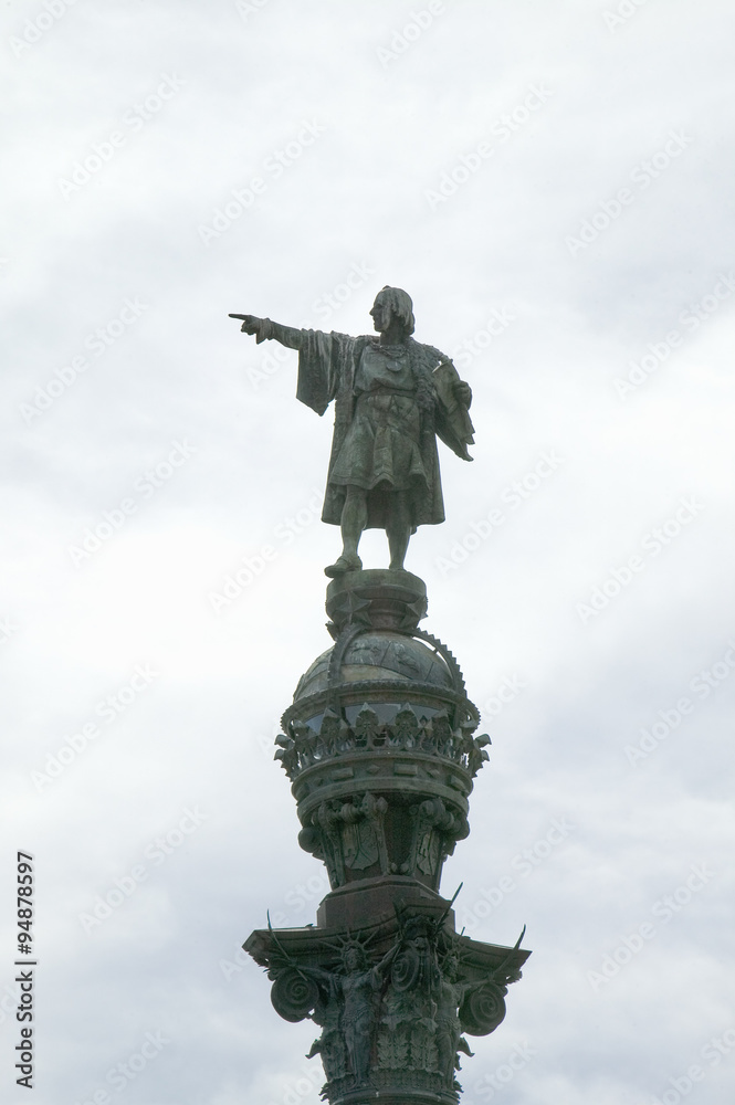 Statue of Christopher Columbus points west over Atlantic Ocean to New World, waterfront of Port Vell, Barcelona, Spain