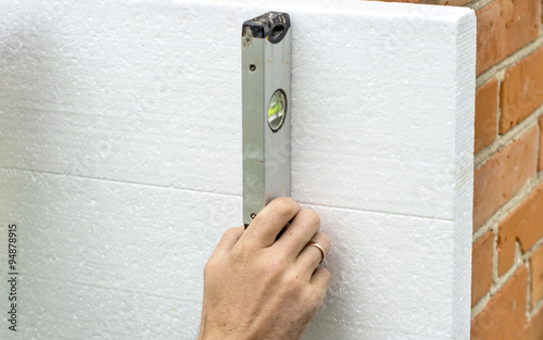 Check flatness of the wall using a level