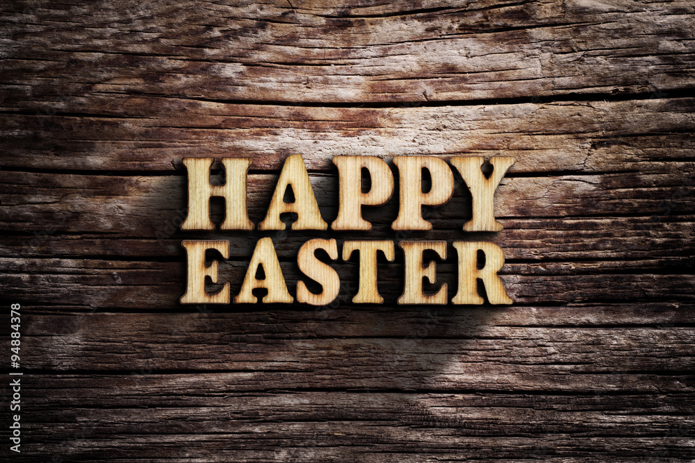 Fototapeta premium Happy Easter. Words on old wooden board.