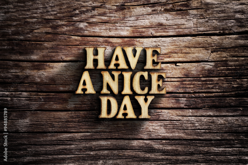 Fototapeta premium Have a nice day. Words on old wooden board.