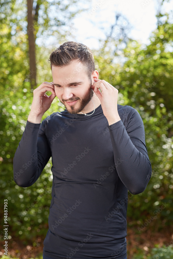 Handsome sporty man tired runner resting after evening jog, fit Handsome sporty man tired runner resting after evening jog, fit