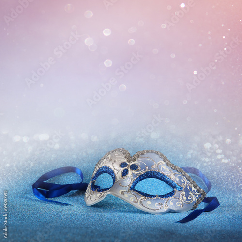 blue female carnival mask and glitter background. with glitter overlay 