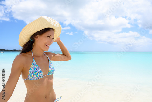 Woman in hat on the beach - girl having fun in sun