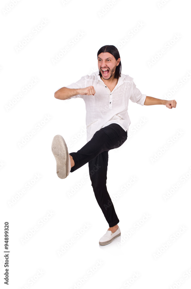Young man kicking isolated on white