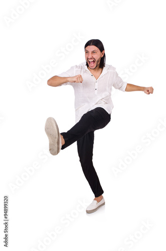 Young man kicking isolated on white