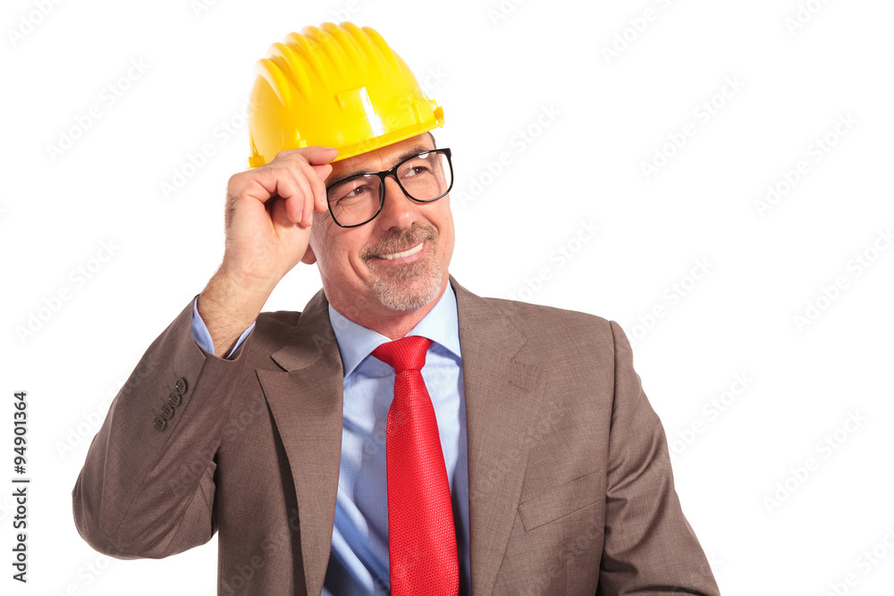 smiling old construction engineer holding his helmet as a greeti smiling old construction engineer holding his helmet as a greeti
