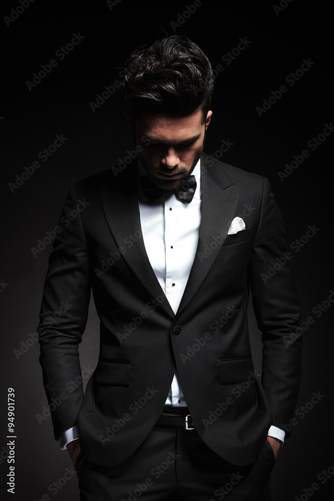 elegant young business man looking down
