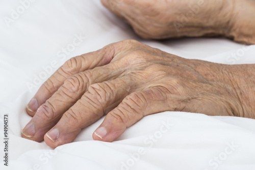 Old hands on the bed photo