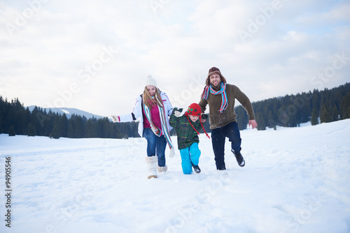 happy family playing together in snow at winter