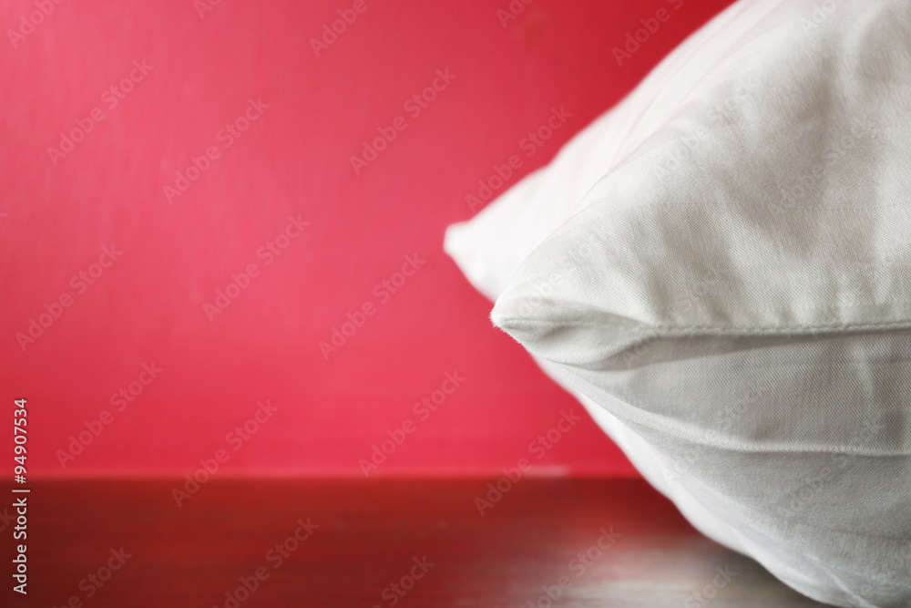 Closeup White Pillow on Red Background. Closeup White Pillow on Red Background.